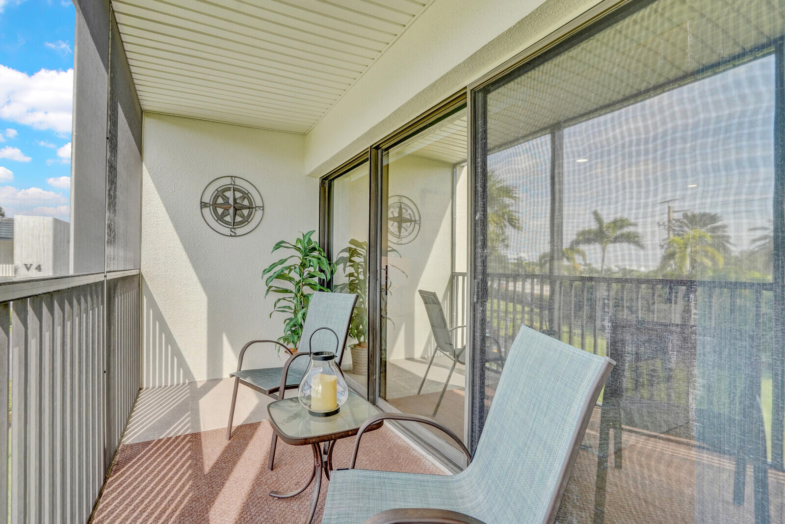 1605 Highway 1, Unit 202V5 Jupiter, FL 33477 - Photo 21 of 26 a view of a chairs and table in patio