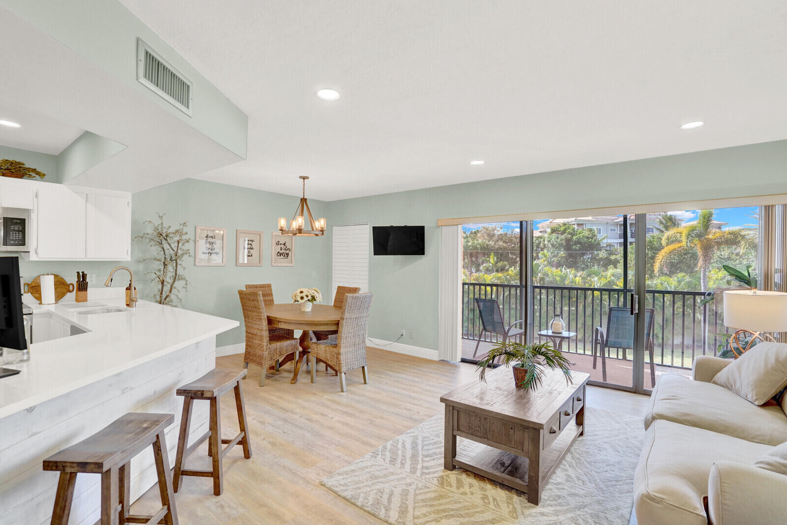 1605 Highway 1, Unit 202V5 Jupiter, FL 33477 - Photo 3 of 26 a living room with furniture and a large window