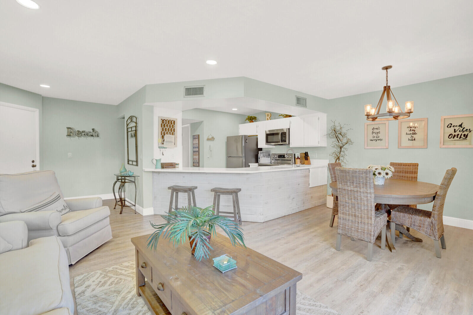 1605 Highway 1, Unit 202V5 Jupiter, FL 33477 - Photo 8 of 26 a living room with furniture and a wooden floor