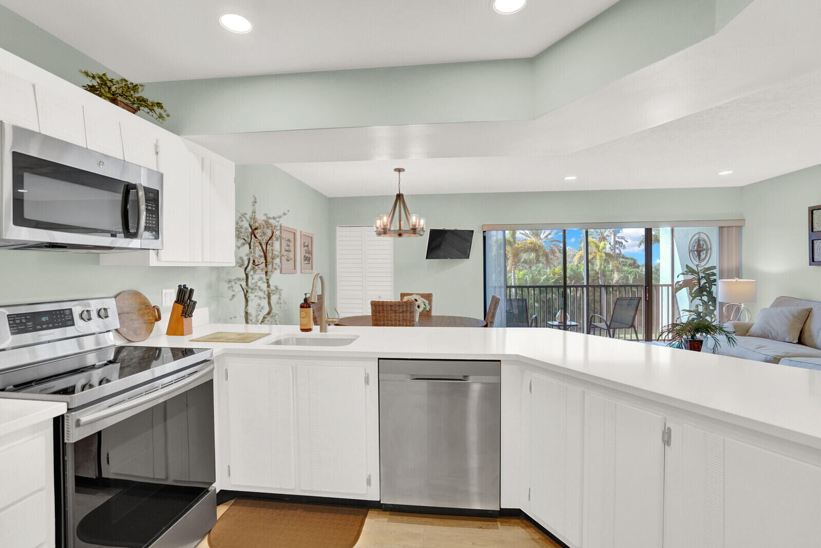 1605 Highway 1, Unit 202V5 Jupiter, FL 33477 - Photo 10 of 26 a kitchen with a sink stove and cabinets