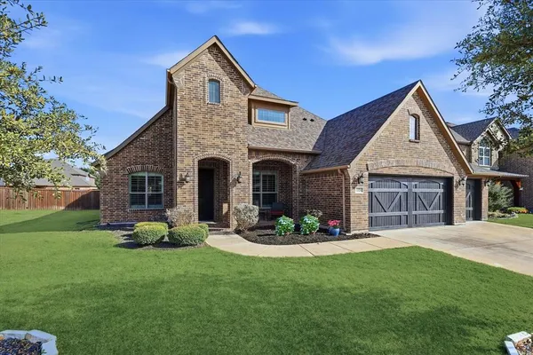 a kitchen with stainless steel appliances granite countertop a stove top oven a refrigerator a sink and dishwasher a oven with wooden cabinets