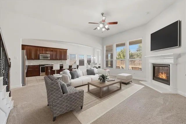 a living room with furniture fireplace and flat screen tv