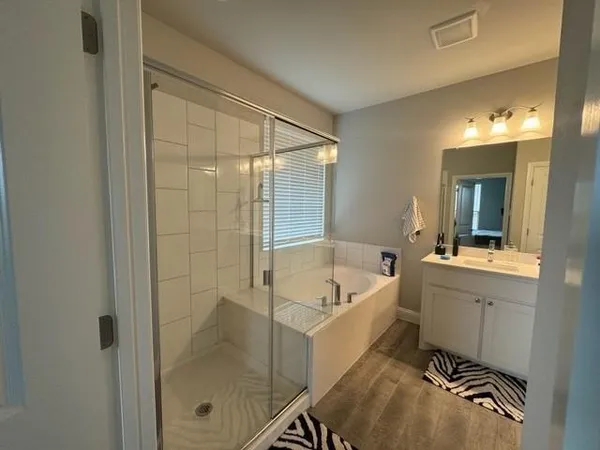 a spacious bathroom with a tub shower and sink