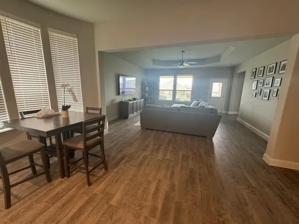 a view of a dining room with furniture and wooden floor