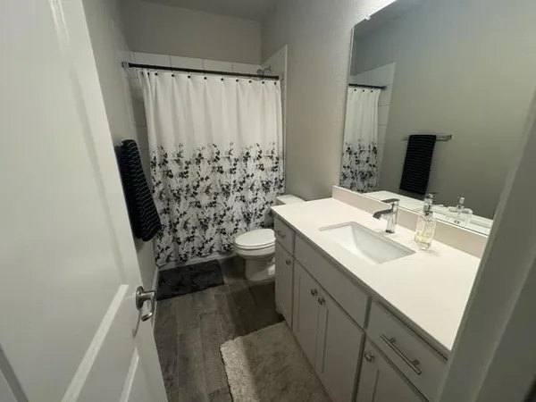 a bathroom with a sink toilet and shower