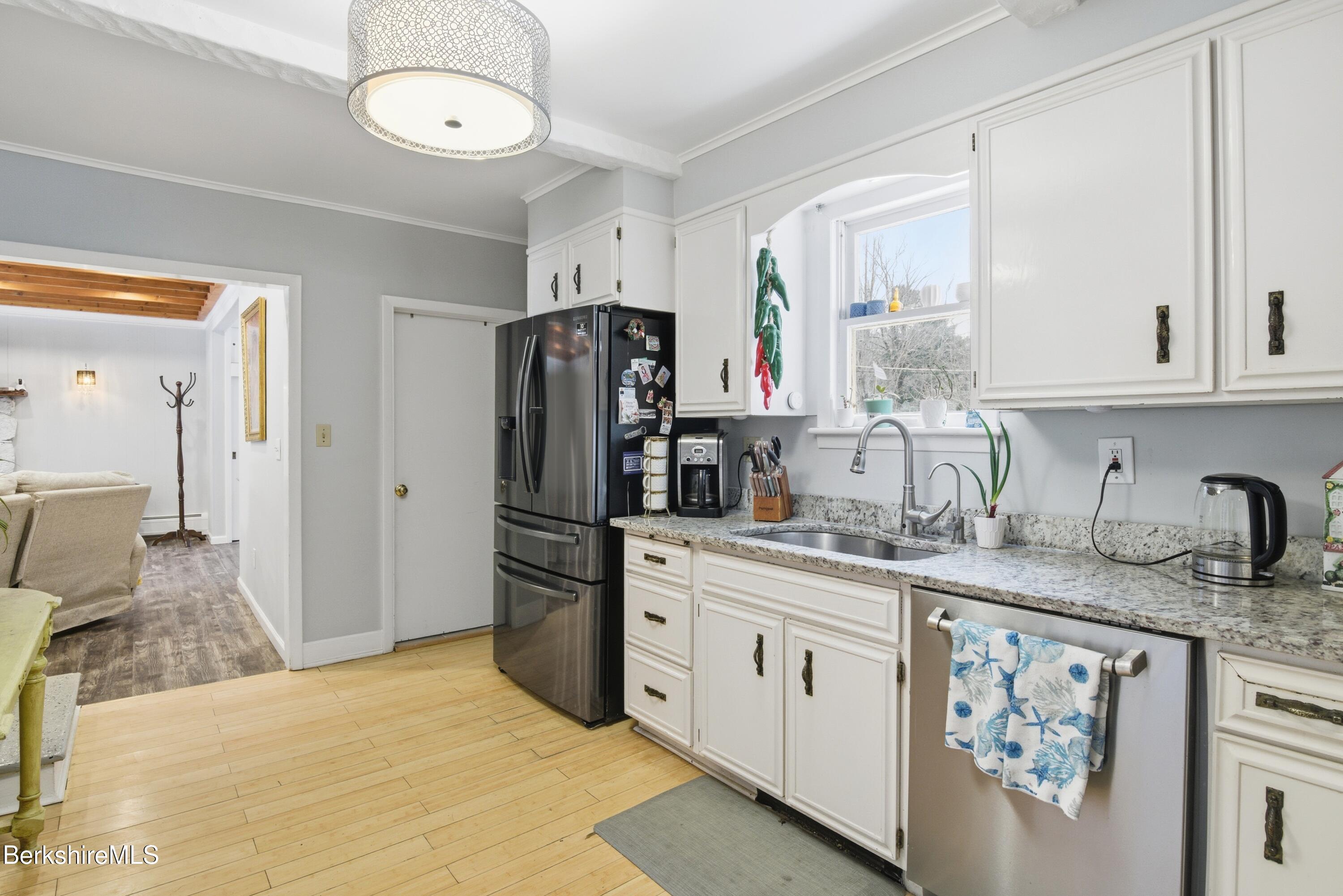 6 Vine Street Pittsfield, MA 01201 - Photo 11 of 37 a kitchen with stainless steel appliances granite countertop a sink stove and refrigerator