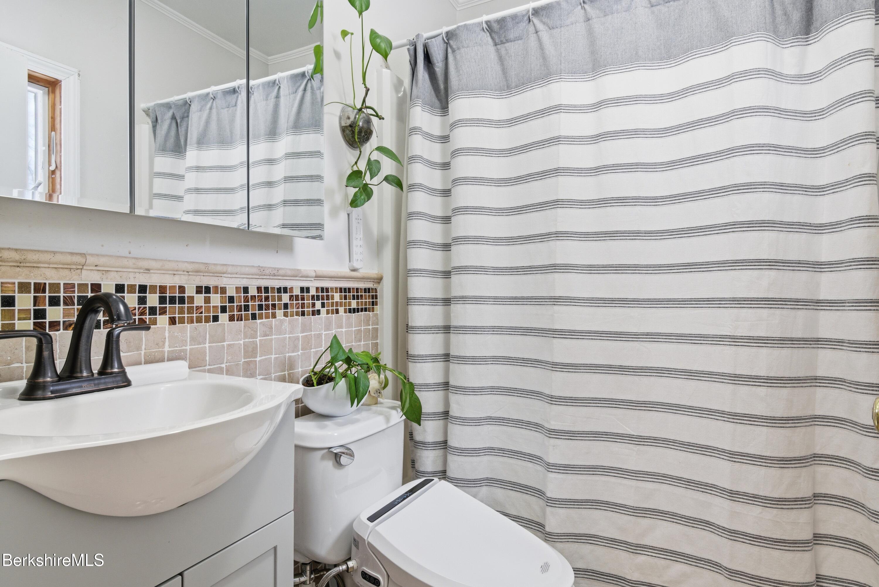 6 Vine Street Pittsfield, MA 01201 - Photo 14 of 37 a bathroom with a sink and a mirror