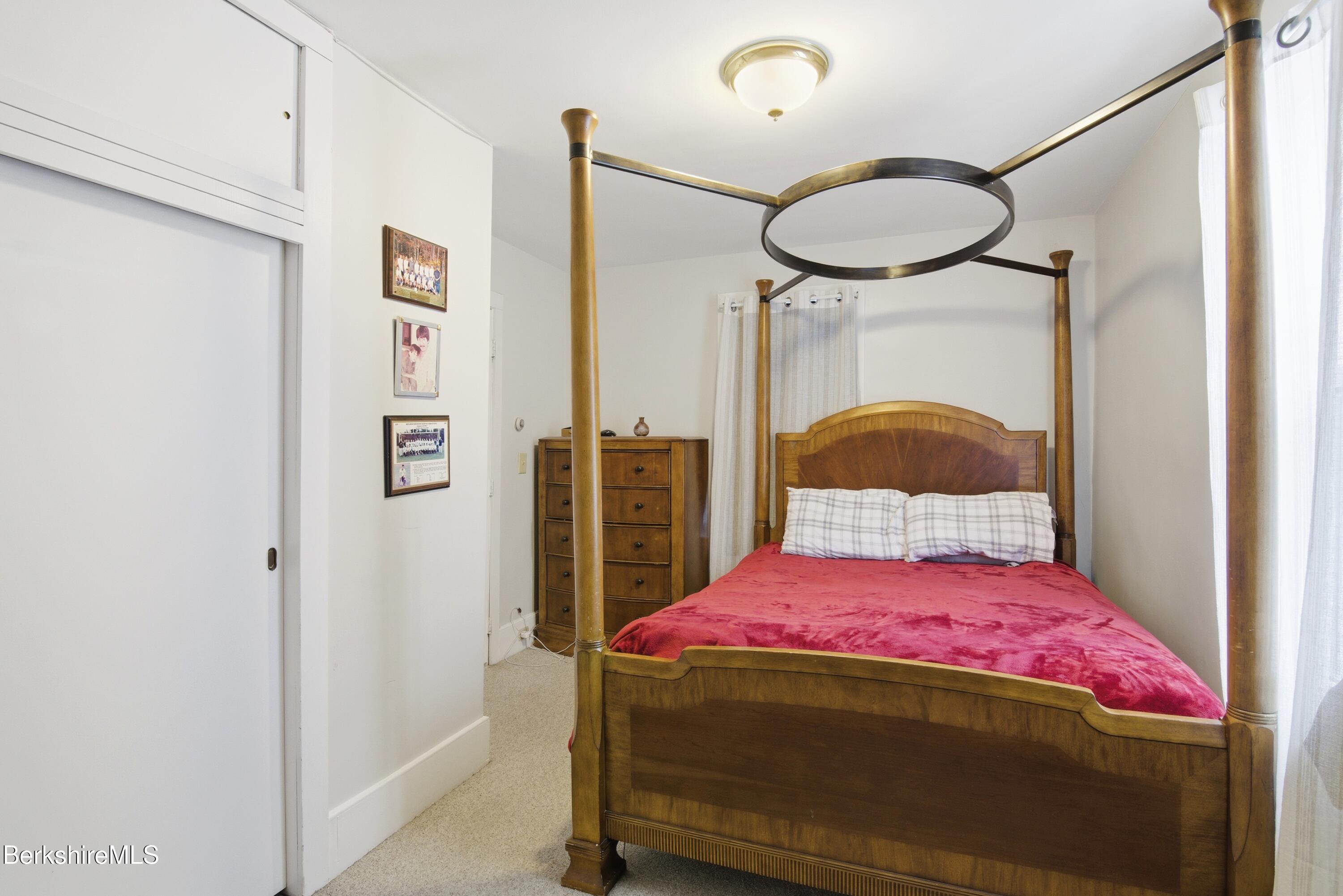 6 Vine Street Pittsfield, MA 01201 - Photo 22 of 37 a bedroom with a bed a dresser and a window