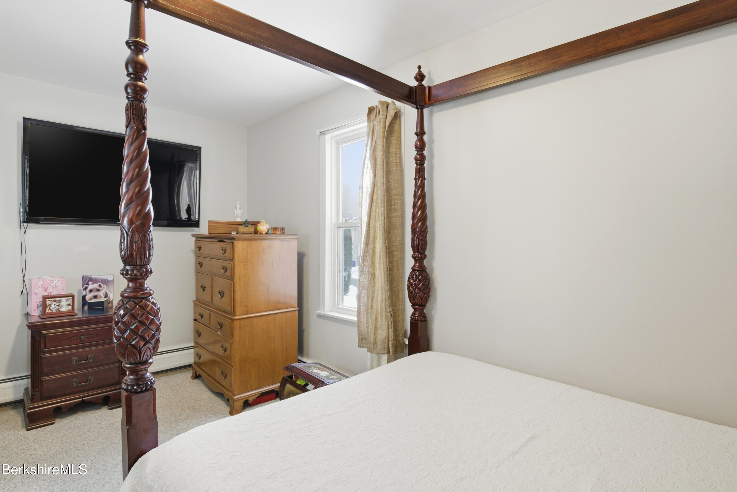 6 Vine Street Pittsfield, MA 01201 - Photo 24 of 37 a bedroom with a bed and a flat screen tv