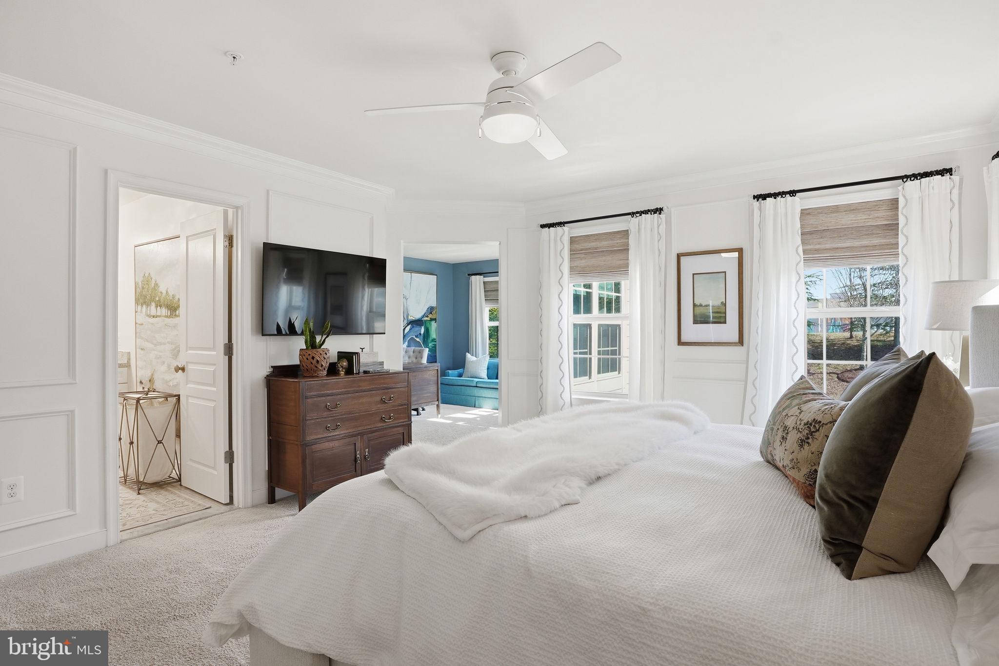 126 Admirals Ridge Drive Arnold, MD 21012 - Photo 16 of 58 a bedroom with a bed flat screen tv and a large window