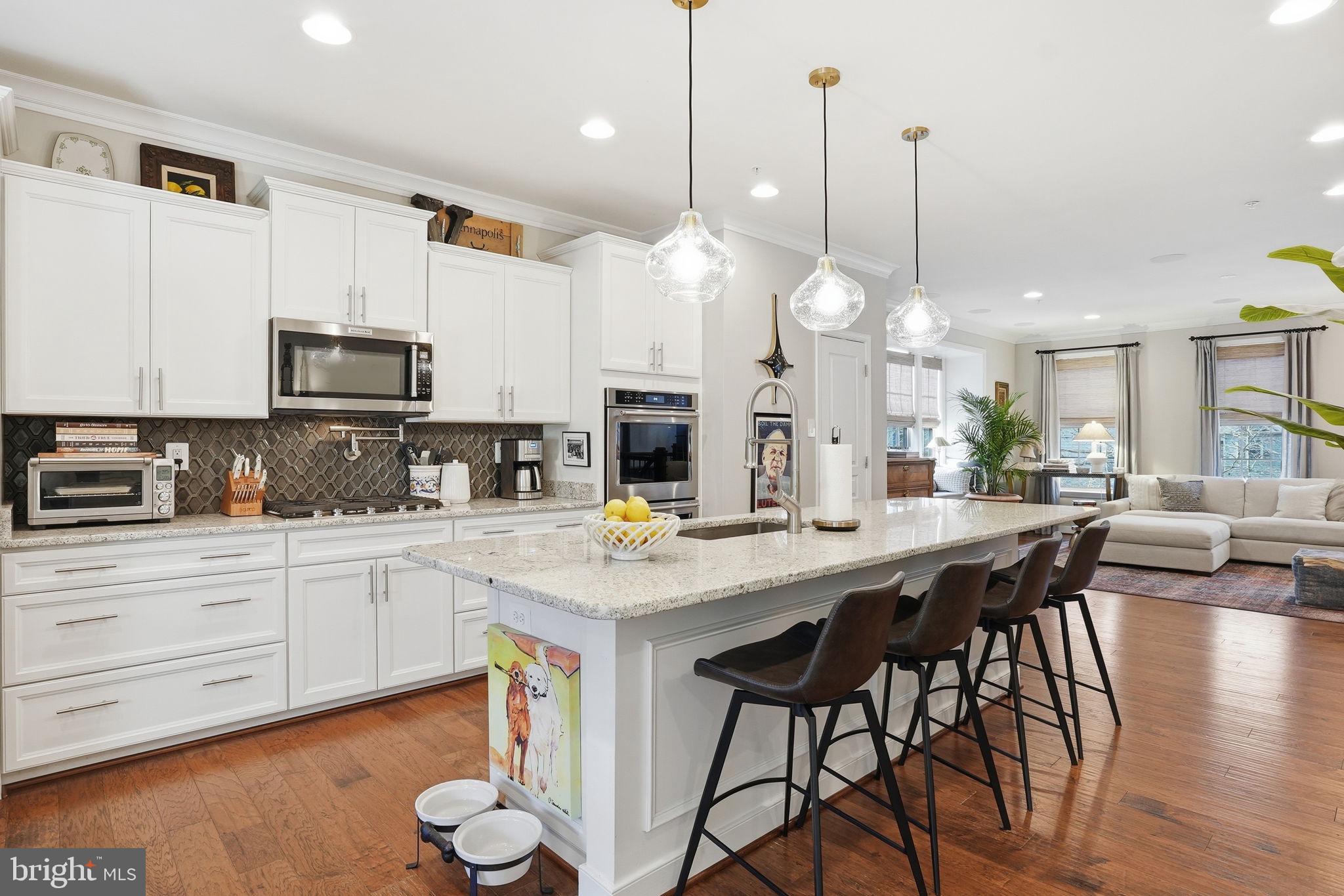 126 Admirals Ridge Drive Arnold, MD 21012 - Photo 5 of 58 a kitchen with stainless steel appliances a table chairs sink and cabinets