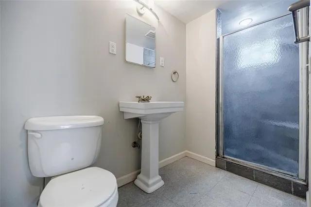 a bathroom with a toilet sink and shower