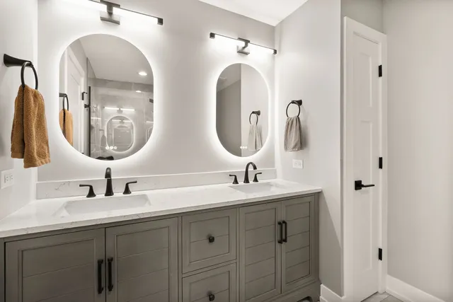 a bathroom with a double vanity sink and a mirror