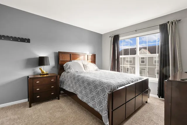 a bedroom with a bed and a window