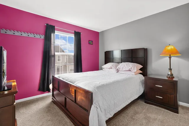 a bedroom with a bed and a lamp