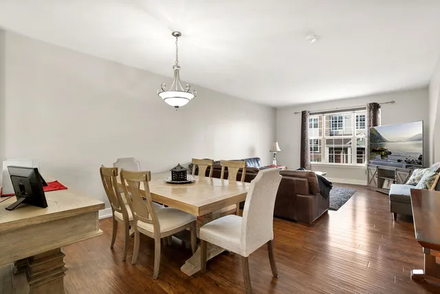 a view of a dining room with furniture wooden floor and chandelier