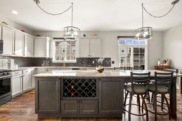 a kitchen with a center island a window and cabinets