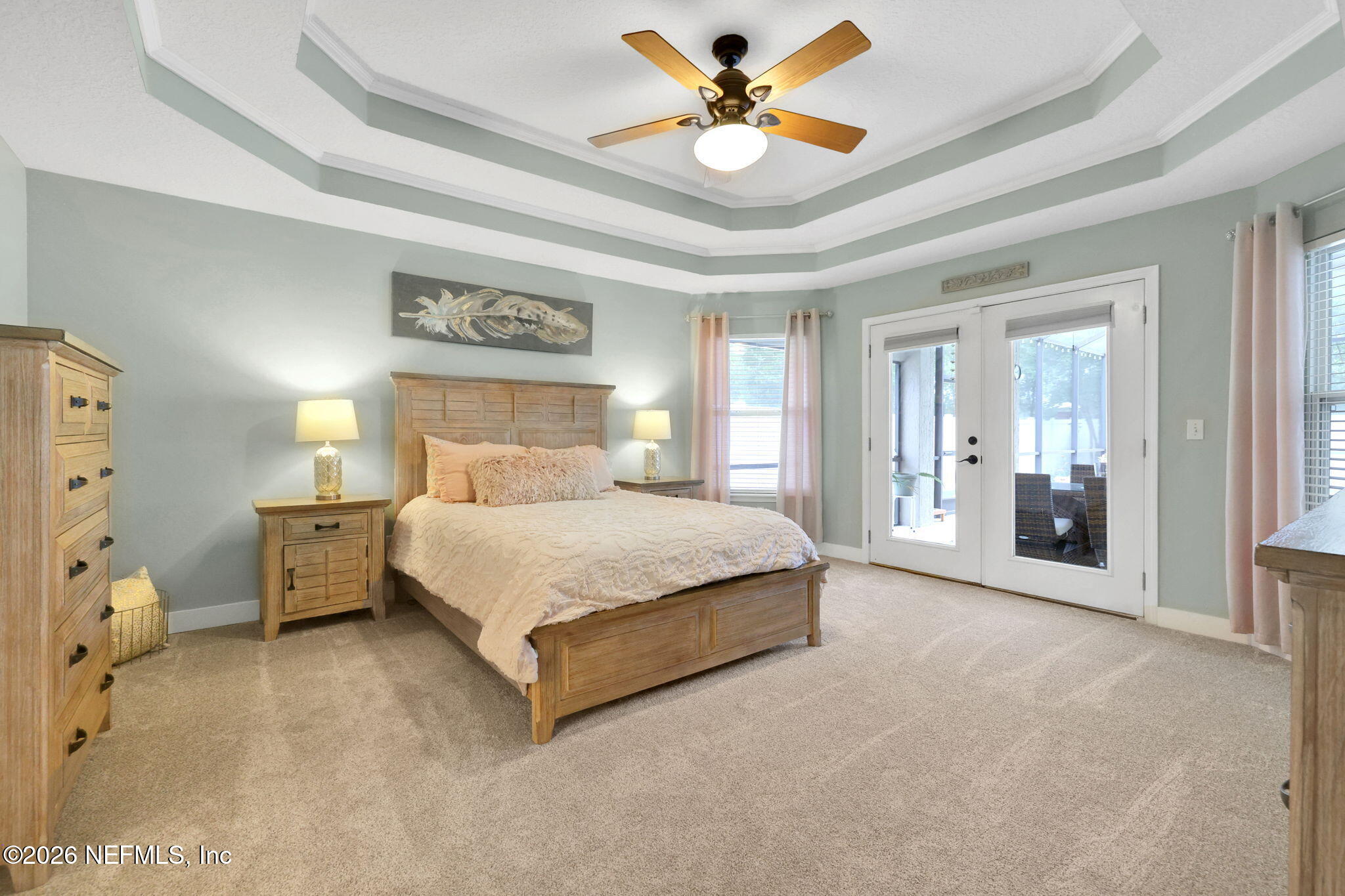4320 Rye Court St. Johns, FL 32259 - Photo 26 of 60 a spacious bedroom with a bed and a chandelier