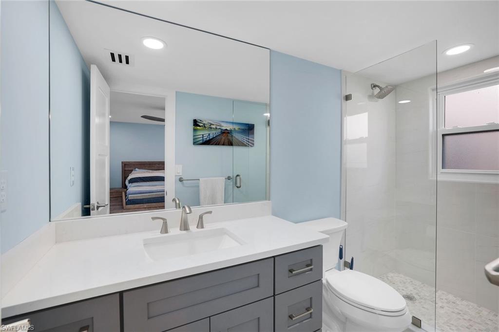 1155 Sandpiper Street, Unit C7 Naples, FL 34102 - Photo 12 of 23 a bathroom with a sink a toilet a shower and a mirror