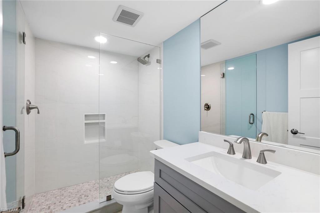 1155 Sandpiper Street, Unit C7 Naples, FL 34102 - Photo 14 of 23 a bathroom with a sink toilet vanity and shower