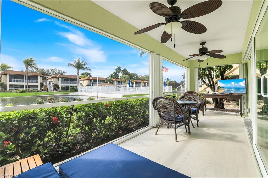1155 Sandpiper Street, Unit C7 Naples, FL 34102 - Photo 16 of 23 a view of a patio with table and chairs and potted plants