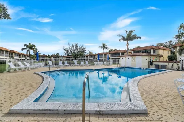 a view of a swimming pool with outdoor seating