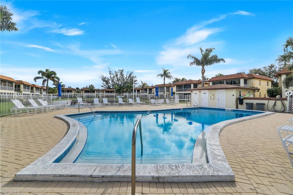 1155 Sandpiper Street, Unit C7 Naples, FL 34102 - Photo 20 of 23 a view of a swimming pool with outdoor seating