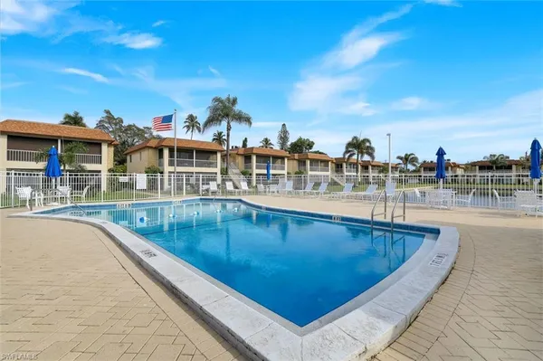 a view of swimming pool with outdoor seating