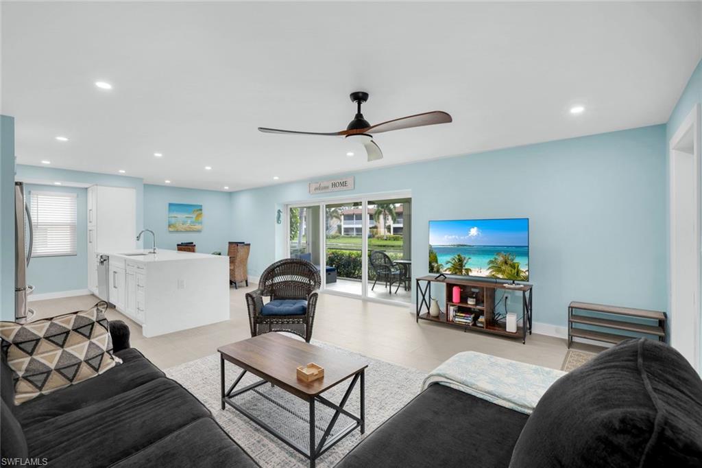 1155 Sandpiper Street, Unit C7 Naples, FL 34102 - Photo 3 of 23 a living room with furniture and a flat screen tv