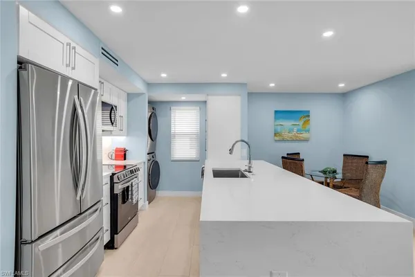 a kitchen with stainless steel appliances a refrigerator and a sink