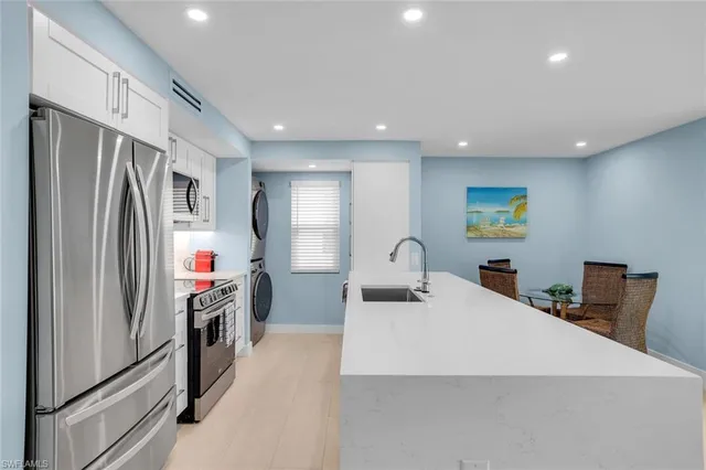 a kitchen with stainless steel appliances a refrigerator and a sink
