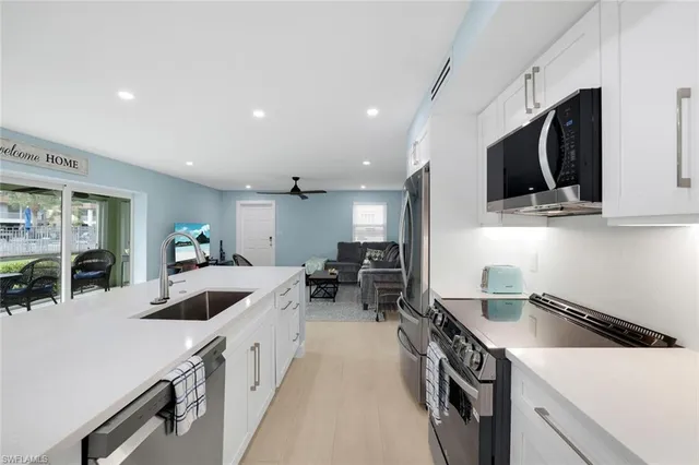 a kitchen with counter top space a sink and appliances