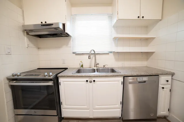 a kitchen with a stove and a sink