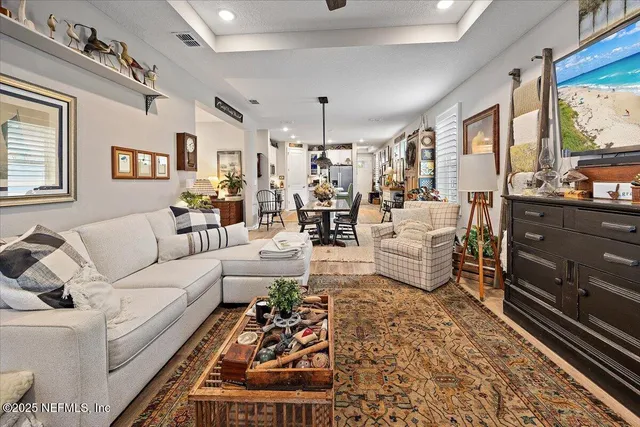 a living room with furniture and a chandelier