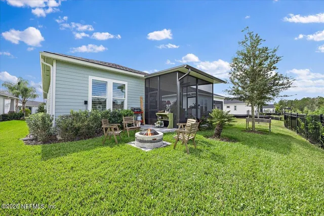 a view of a house with backyard sitting area and garden