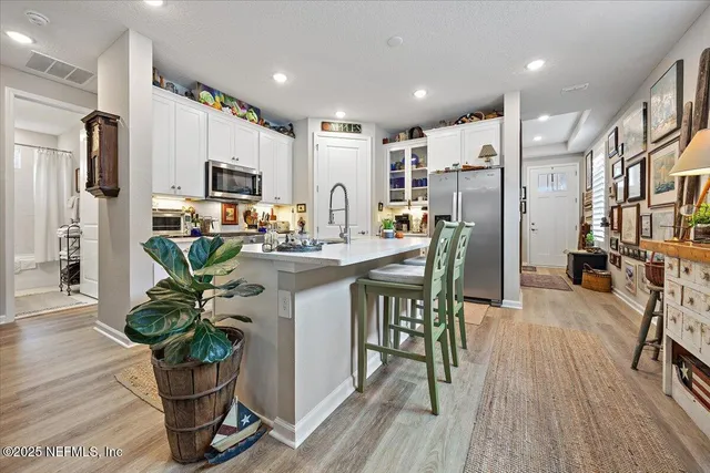 a dining room filled with furniture and wooden floor