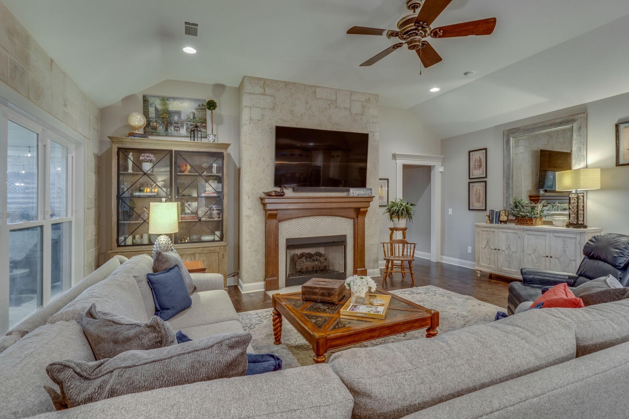 2218 Dunblane Lane Franklin, TN 37069 - Photo 8 of 23 a living room with furniture a flat screen tv and a fireplace