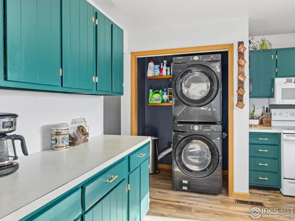 a utility room with sink dryer and washer