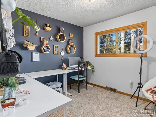 a workspace with furniture and painting on the wall