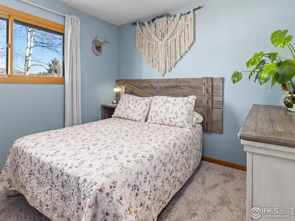 a bedroom with a bed and a painting on the wall