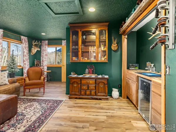 a living room with furniture a window and kitchen view