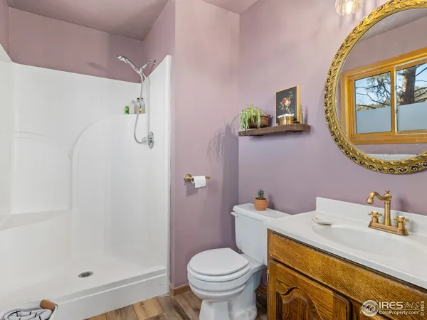 a bathroom with a granite countertop toilet sink and mirror