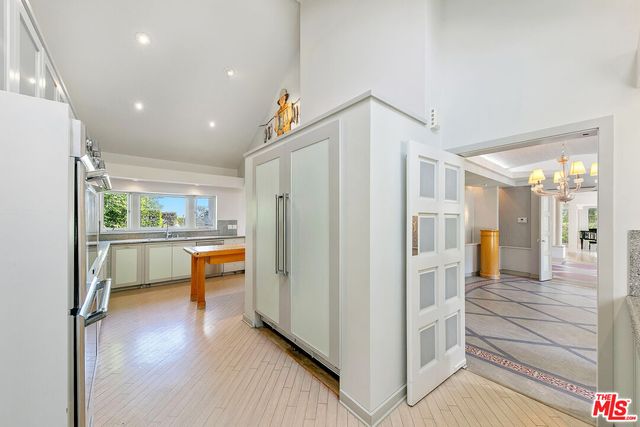 a view of a house with wooden walls and flower plants