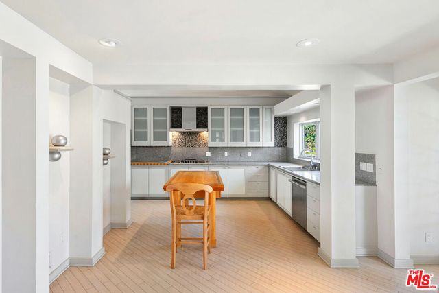 a kitchen with stainless steel appliances granite countertop a sink and a window