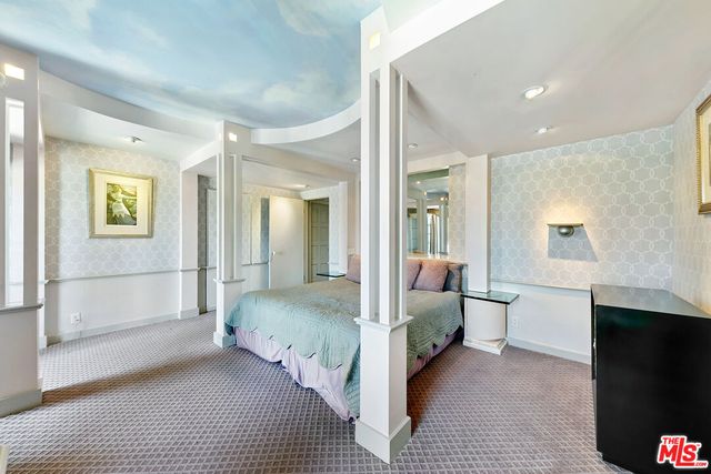 a living room with furniture and a glass door shower