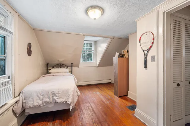 a bedroom with a bed and a mirror