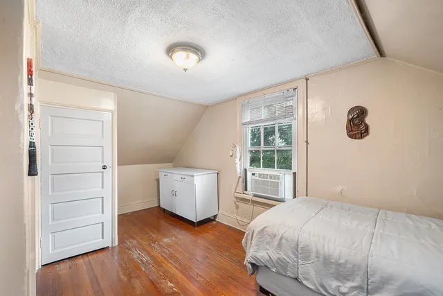 a spacious bedroom with a bed and a window