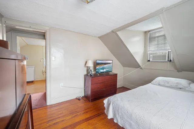 a bedroom with a bed and a dresser