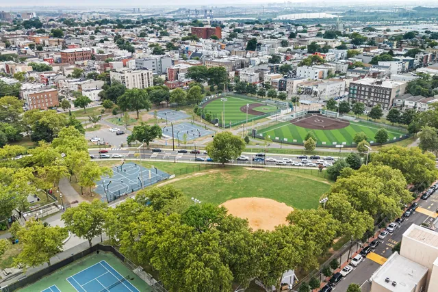 an aerial view of residential houses with outdoor space and swimming pool