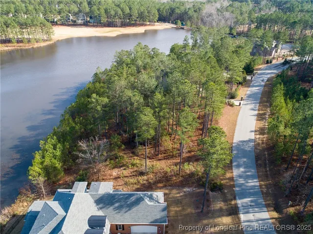 a backyard of a house with a yard and outdoor seating